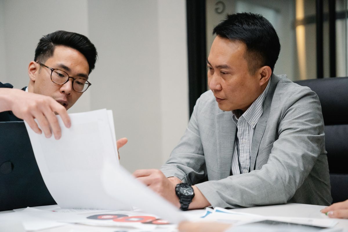 Two advisers reviewing a debt consolidation case